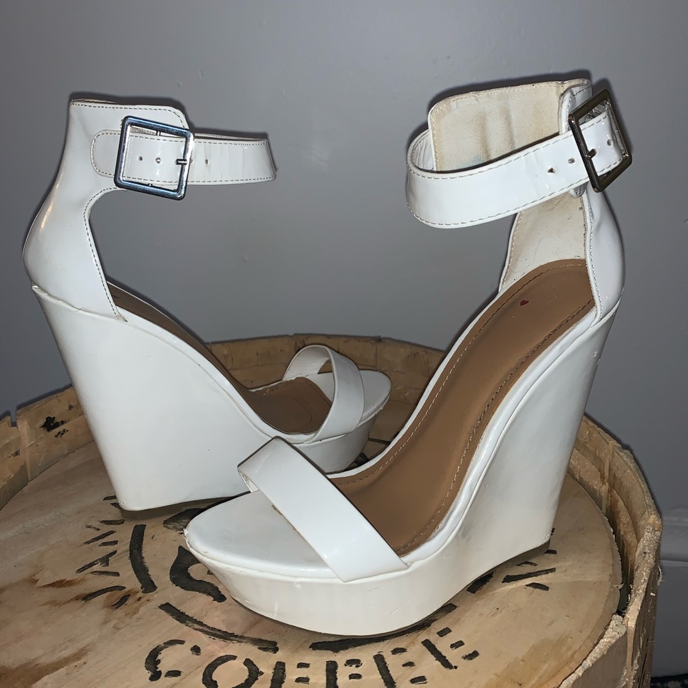 White sandal style wedges with thick ankle strap.